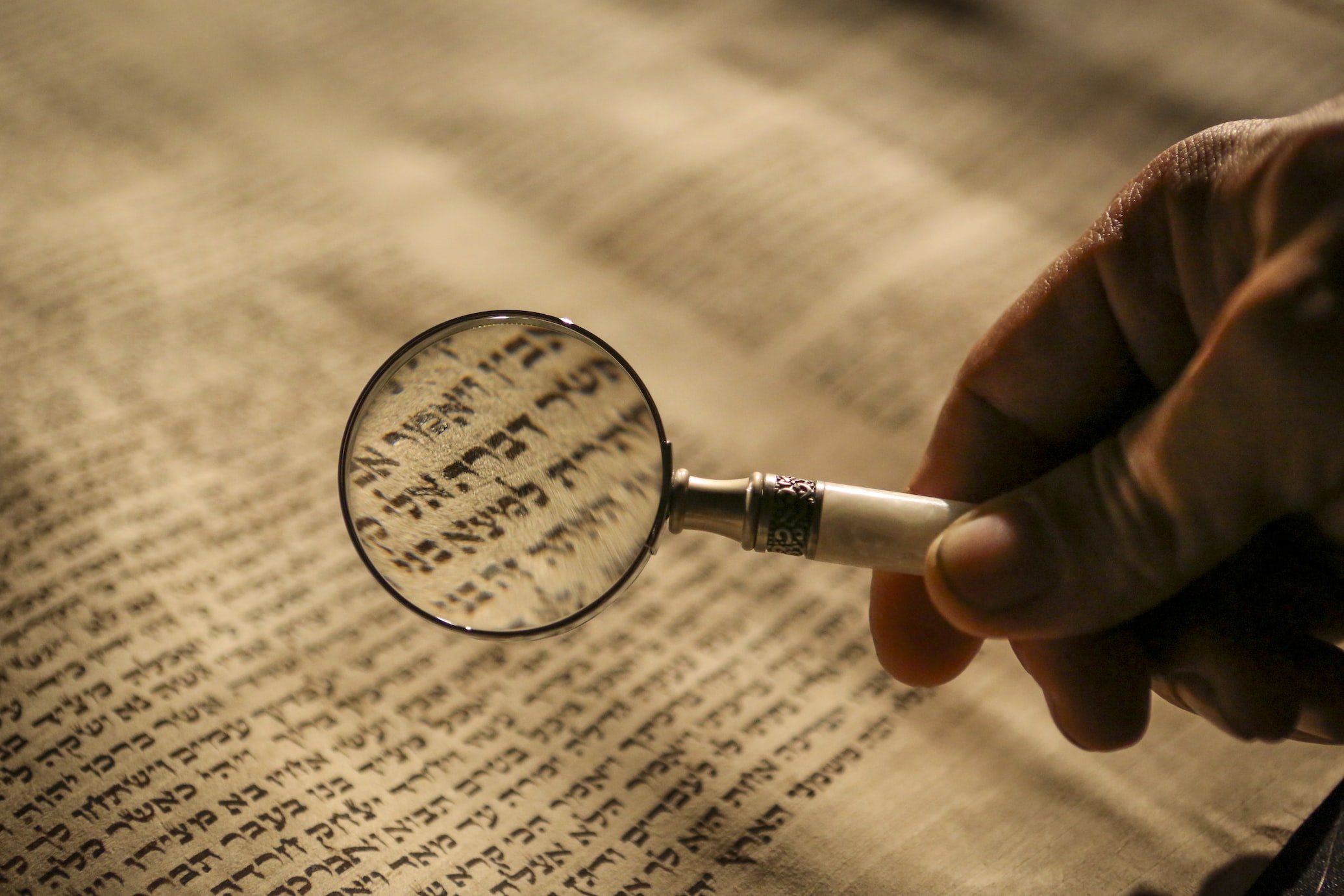 Picture of Hebrew Bible text viewed through a magnifying glass