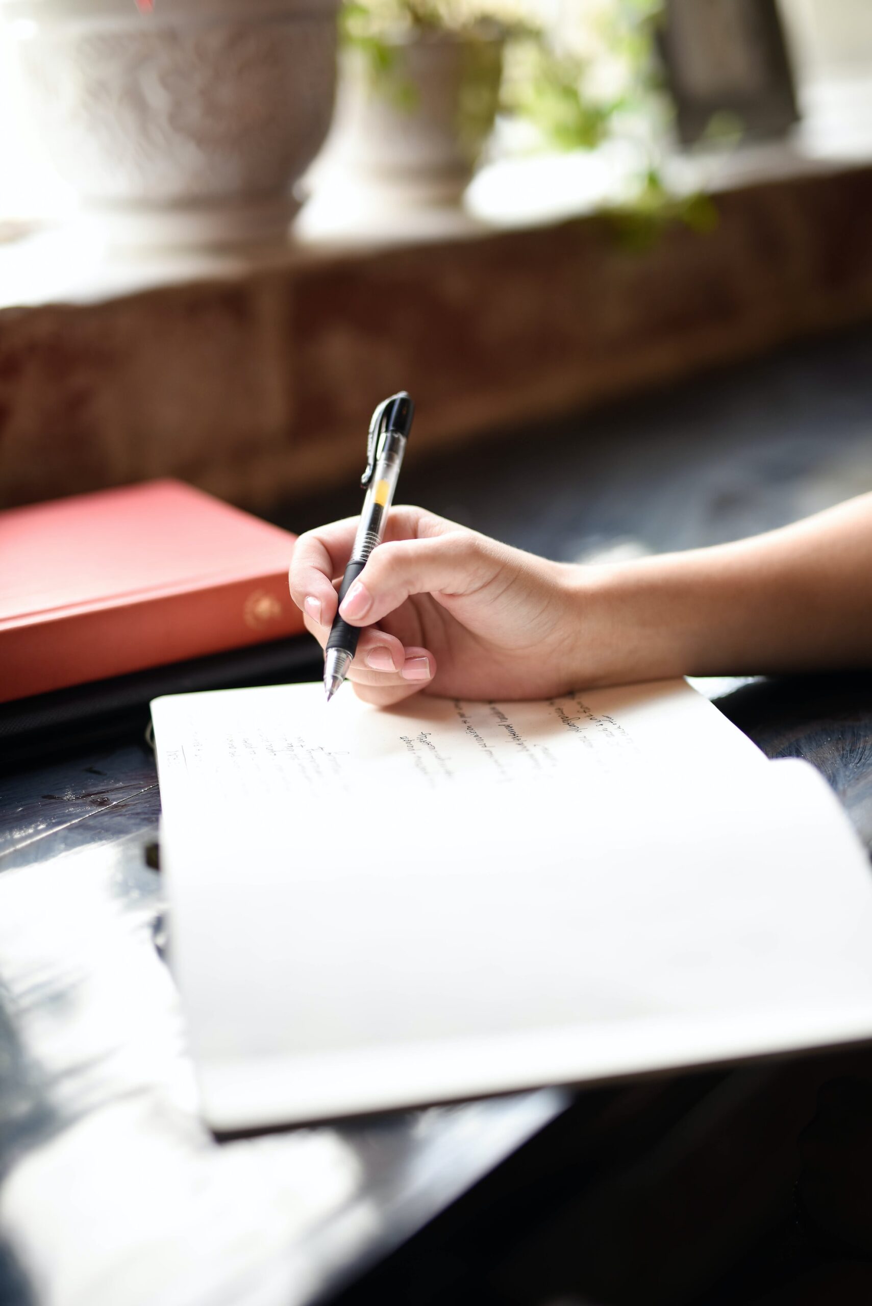 Picture of a hand writing in a book