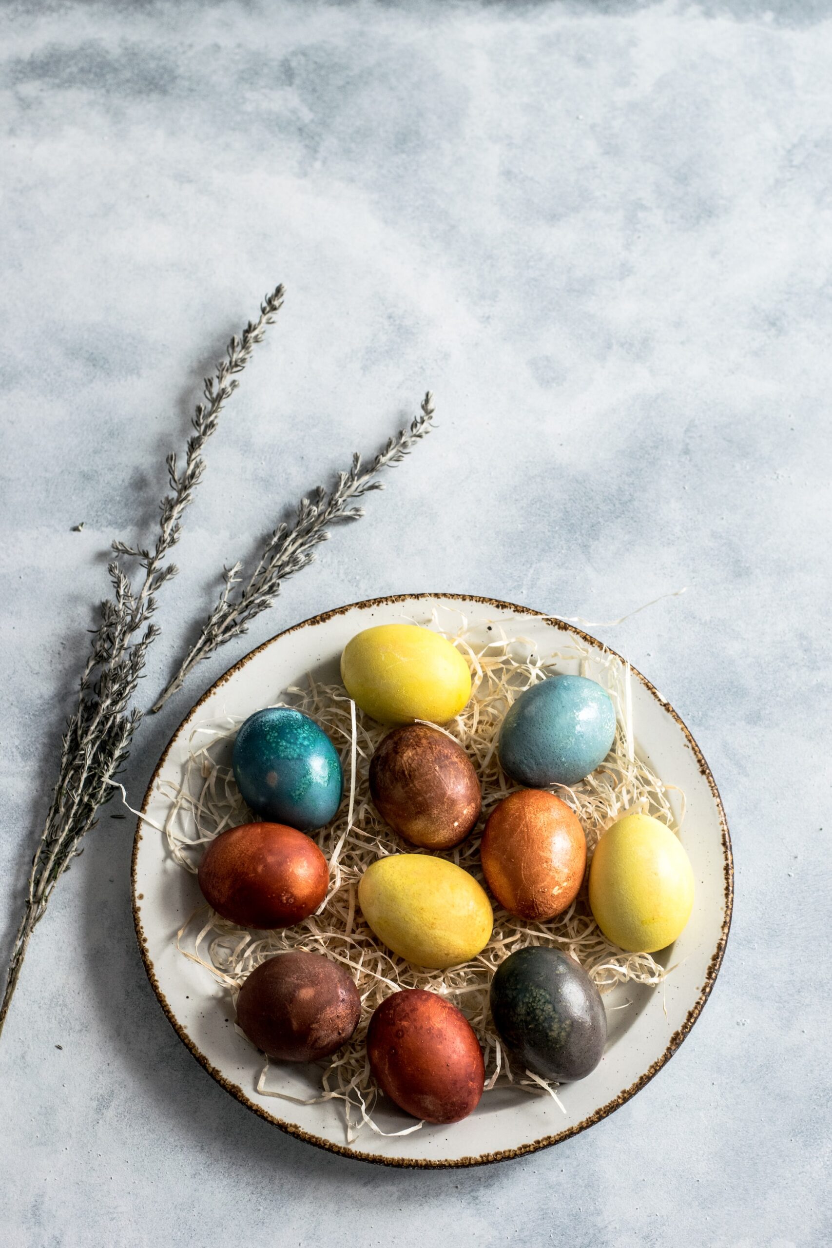 Assorted dyed eggs on a ceramic tray