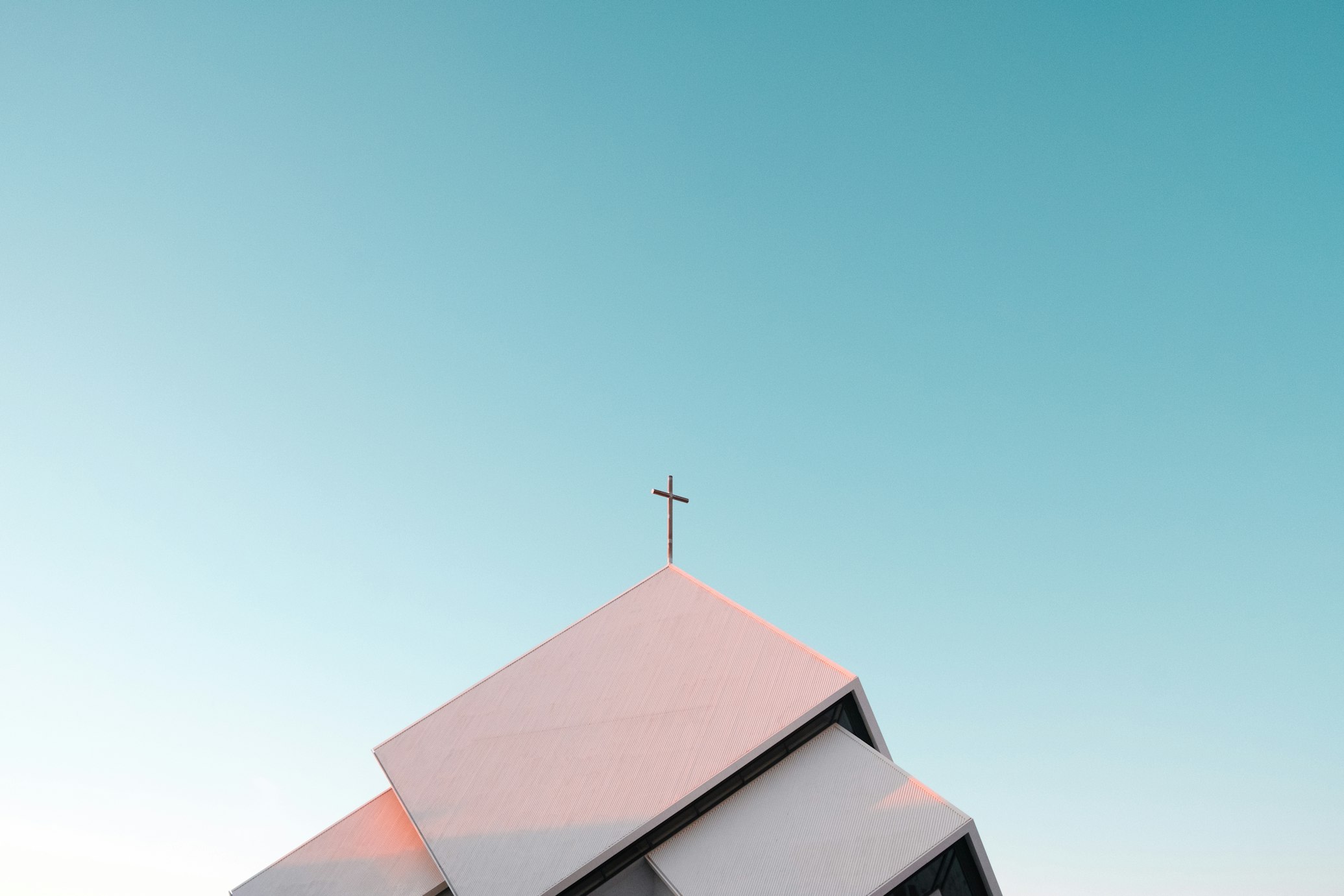 Photo of a modern steeple against a plain blue sky