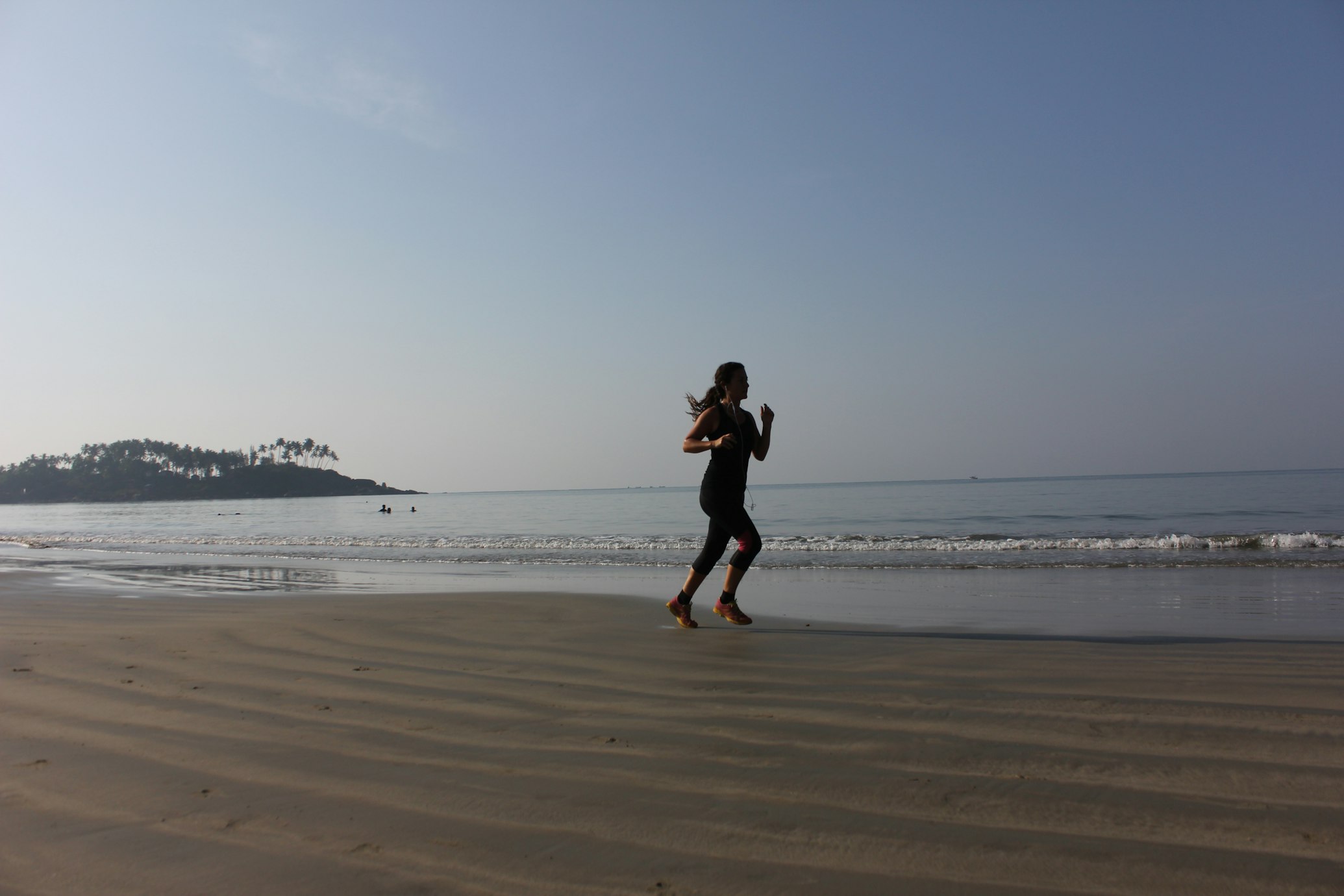 Photo of a woman running on the beach