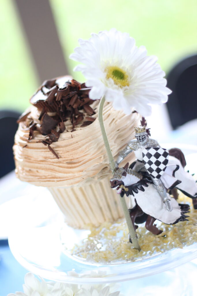 Photo of our wedding cake, decorated with a knight holding a giant daisy.