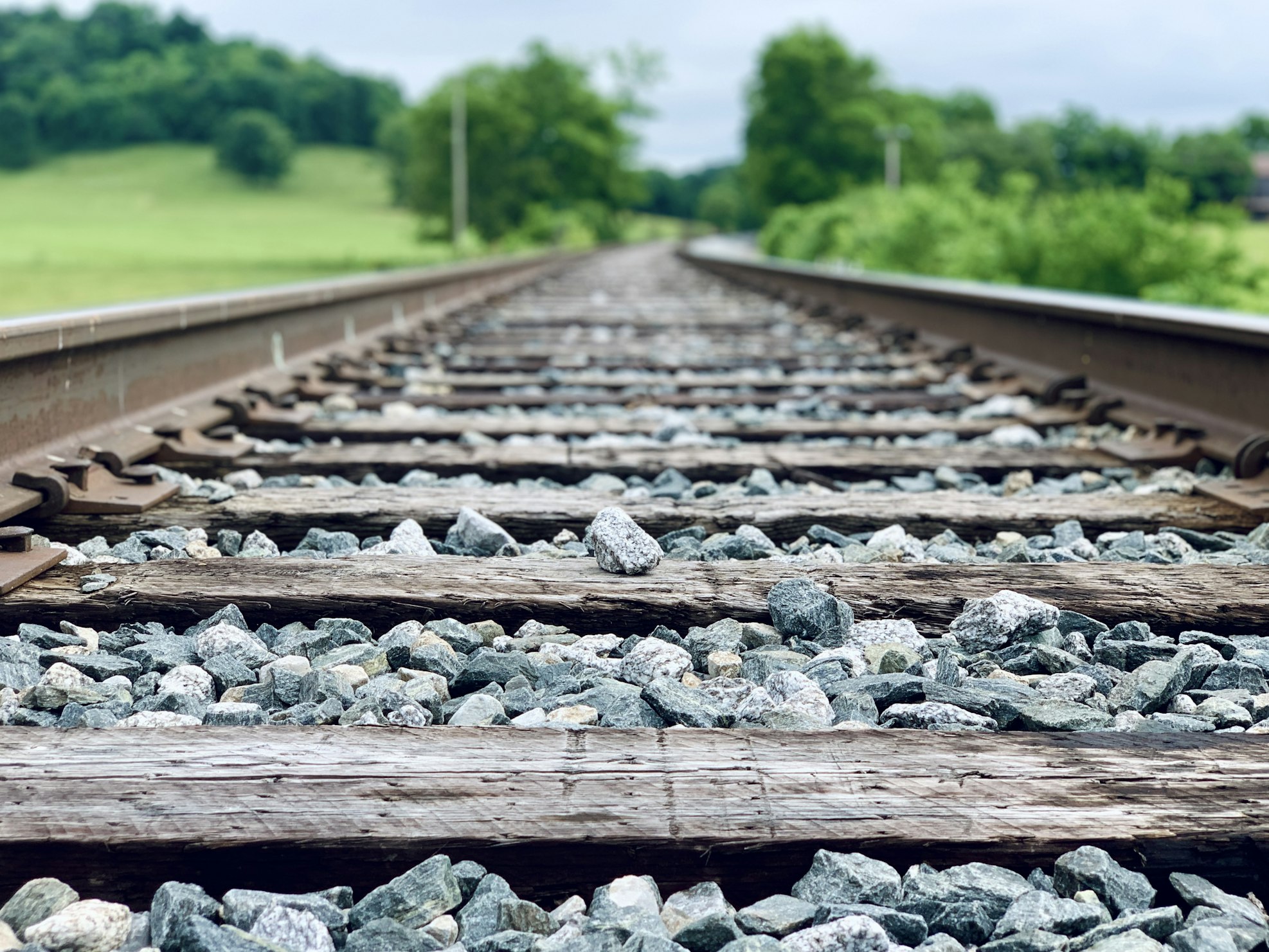 A closeup photo of railroad tracks, taken from between the tracks near ground level.