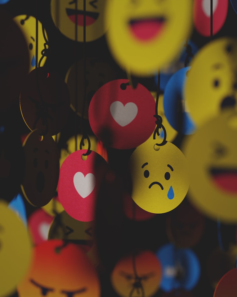 A picture of assorted reaction emojis dangling from strings