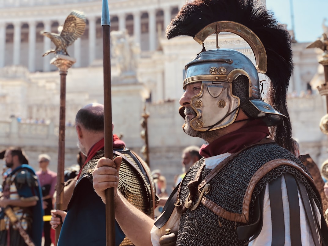 Roman Soldiers among a crowd at an ancient site.